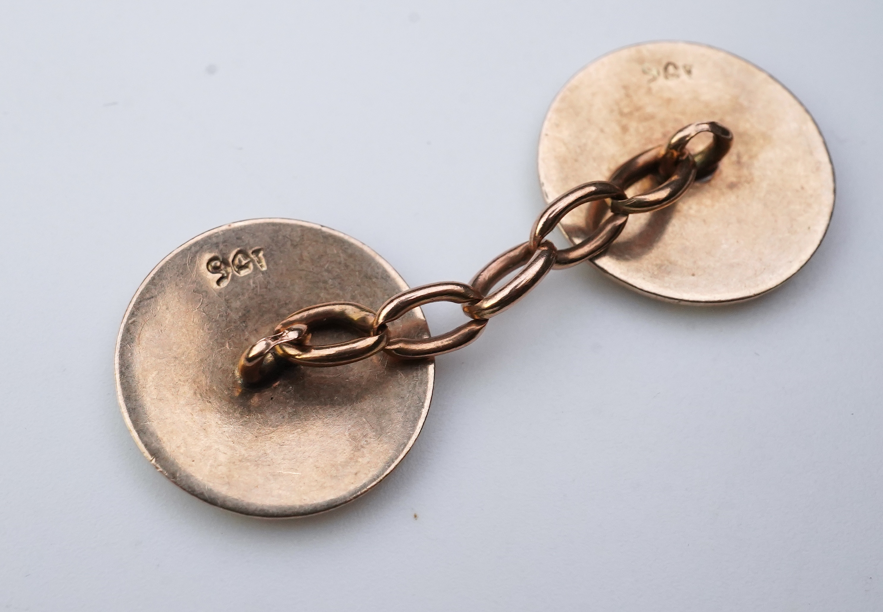 A pair of gold and enamel cufflinks